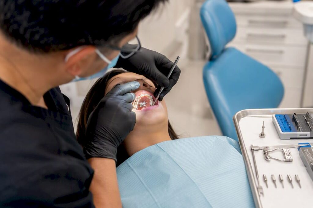 Dentist adjusting adult palatal expansion device