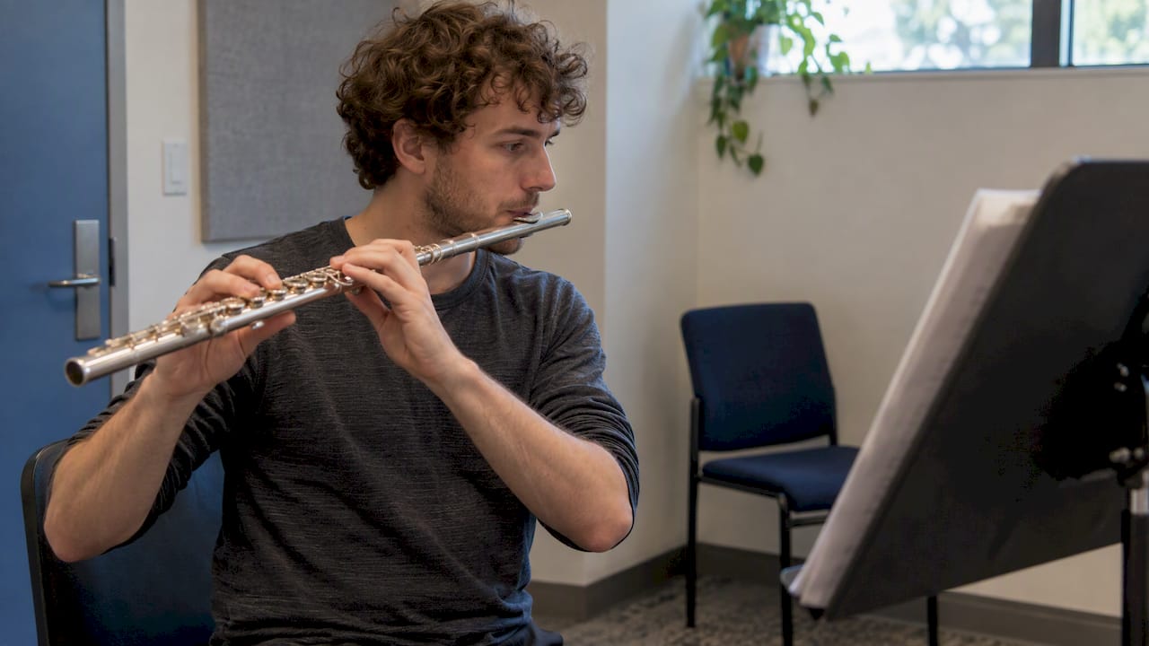Adult playing flute as a tongue-control check
